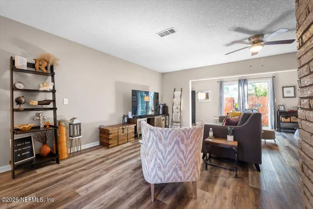 a living room with furniture and wooden floor