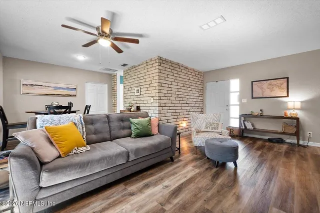 a living room with furniture wooden floor and window