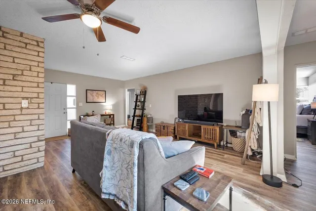 a living room with furniture and a flat screen tv