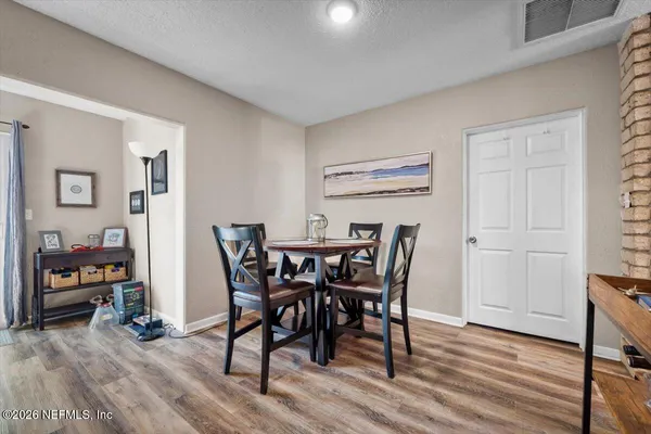 a view of a dining room with furniture and wooden floor