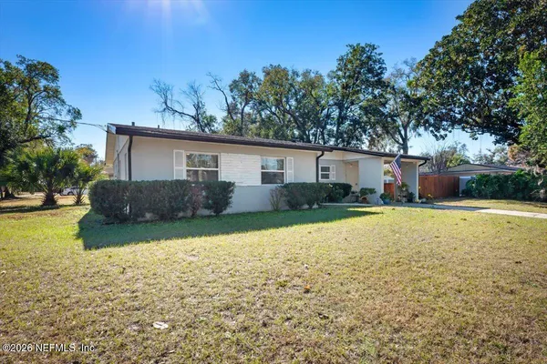 a front view of house with yard and trees