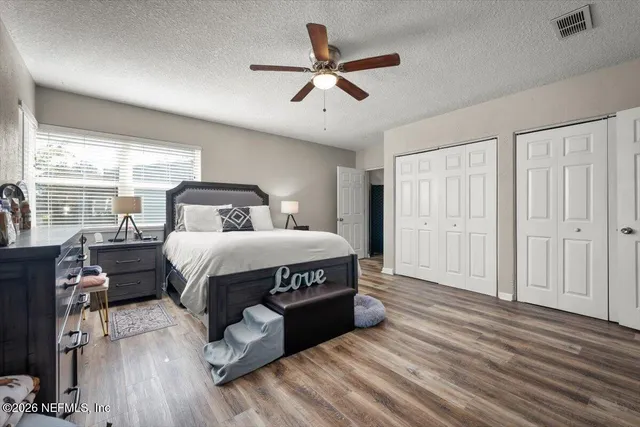 a bedroom with a bed window and a ceiling fan