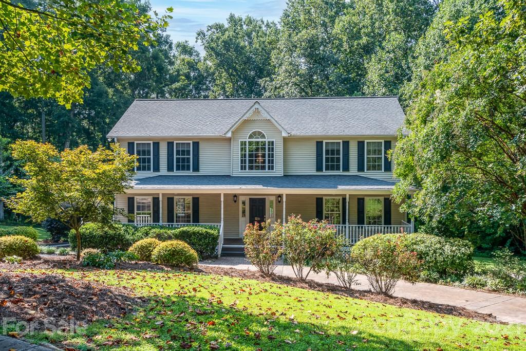 7230 Denmark Drive Denver, NC 28037 - Photo 1 of 41 a front view of a house with a yard and potted plants