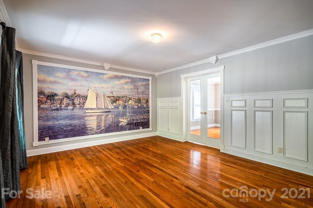 7230 Denmark Drive Denver, NC 28037 - Photo 11 of 41 a view of an empty room with wooden floor and a window