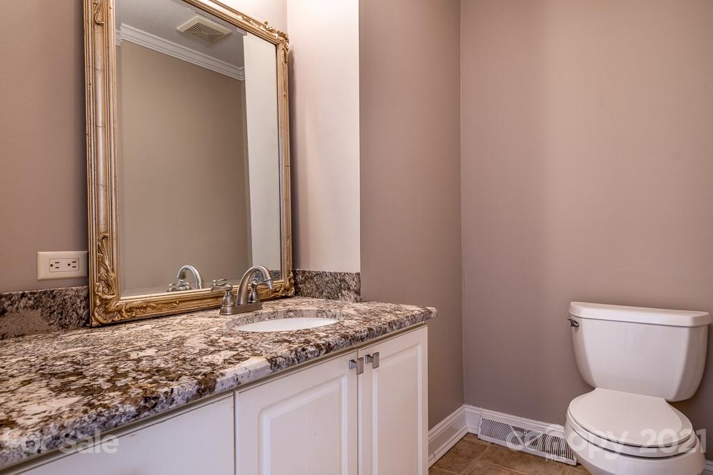 7230 Denmark Drive Denver, NC 28037 - Photo 13 of 41 a bathroom with a granite countertop toilet sink and mirror