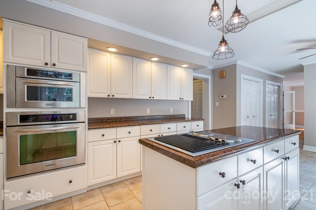 7230 Denmark Drive Denver, NC 28037 - Photo 16 of 41 a kitchen with granite countertop stainless steel appliances a stove cabinets and microwave
