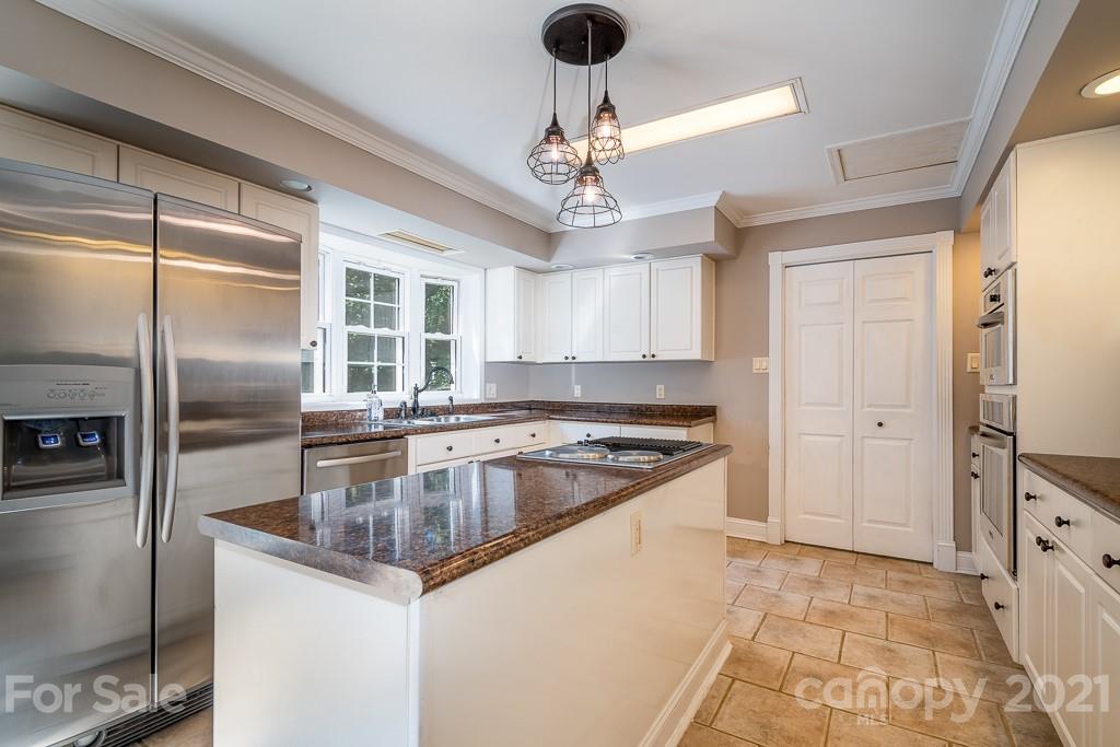 7230 Denmark Drive Denver, NC 28037 - Photo 17 of 41 a kitchen with stainless steel appliances granite countertop a sink a counter space and a refrigerator