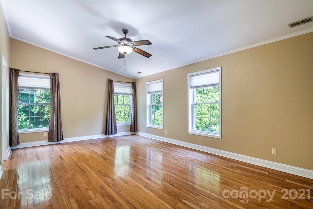 7230 Denmark Drive Denver, NC 28037 - Photo 19 of 41 a view of an empty room with a window and wooden floor