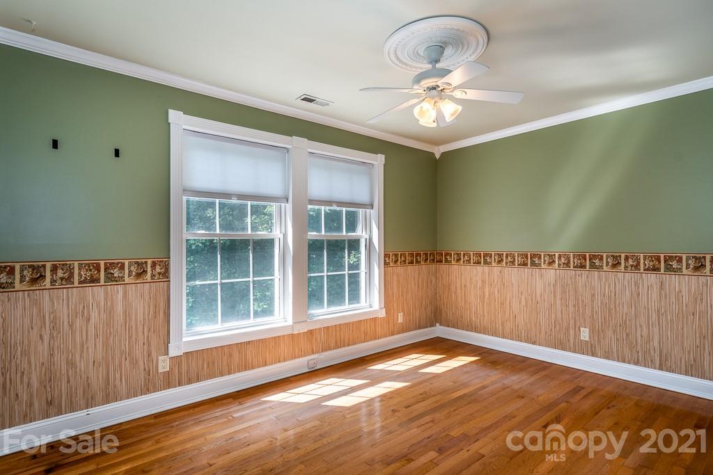 7230 Denmark Drive Denver, NC 28037 - Photo 22 of 41 a view of an empty room with a window and wooden floor