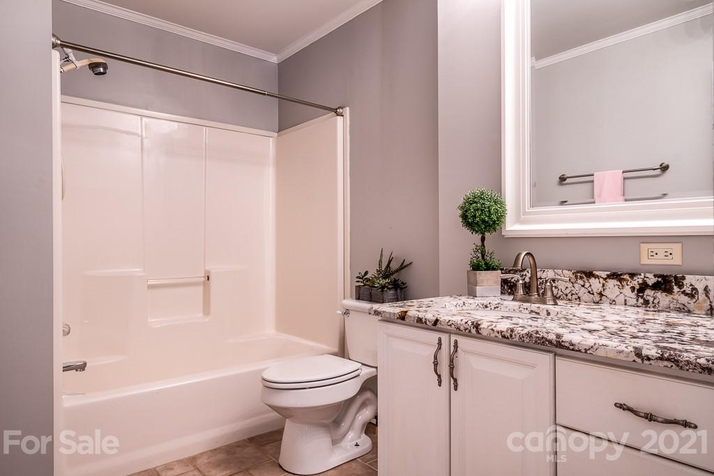 7230 Denmark Drive Denver, NC 28037 - Photo 23 of 41 a bathroom with a granite countertop sink toilet and shower