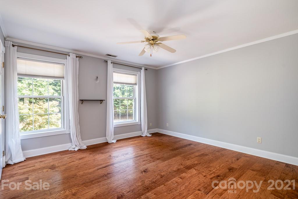 7230 Denmark Drive Denver, NC 28037 - Photo 25 of 41 an empty room with wooden floor fan and windows