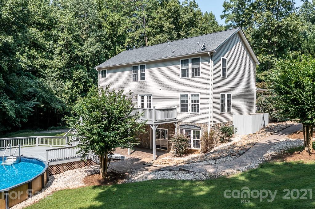 7230 Denmark Drive Denver, NC 28037 - Photo 32 of 41 a view of a yard in front of a house with plants and large tree