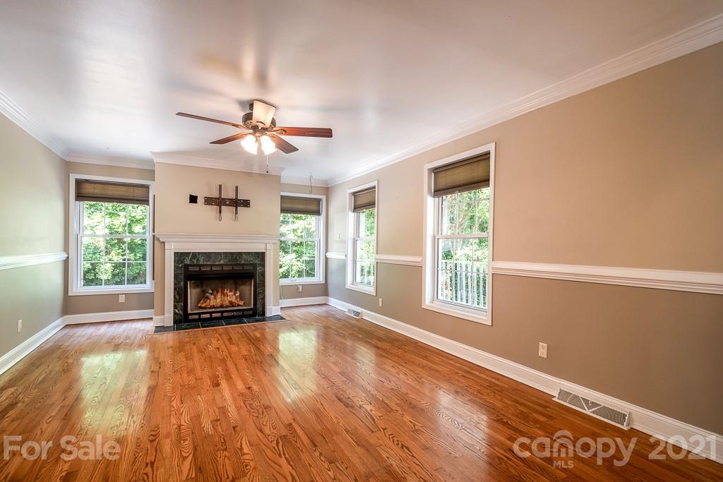 7230 Denmark Drive Denver, NC 28037 - Photo 10 of 41 a view of an empty room with a fireplace and a window