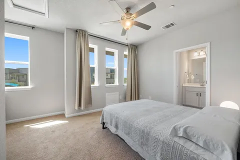 a bedroom with a large bed and a chandelier