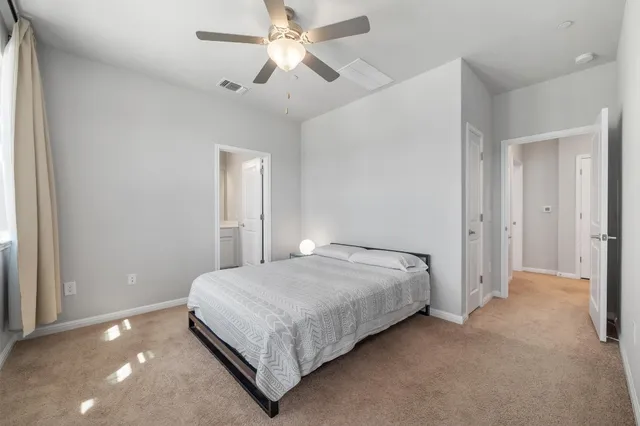 a bedroom with a bed and a ceiling fan