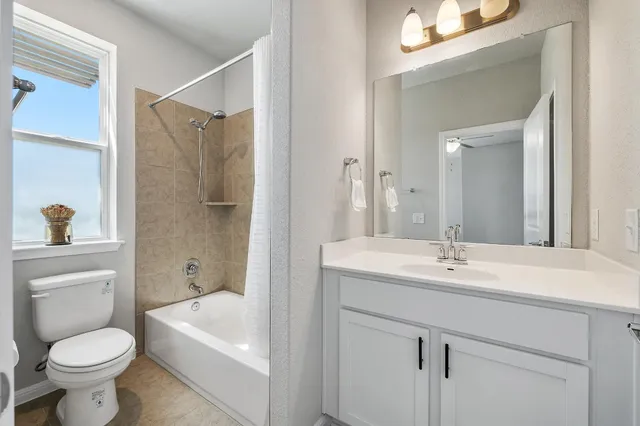 a bathroom with a sink toilet vanity and tub