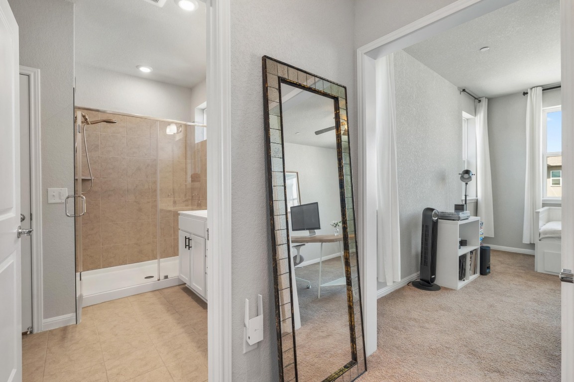 9015 Cattle Baron Path, Unit 403 Austin, TX 78747 - Photo 22 of 40 a bathroom with a glass shower door
