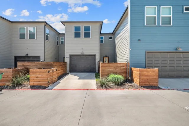 a backyard of a house with table and sofas