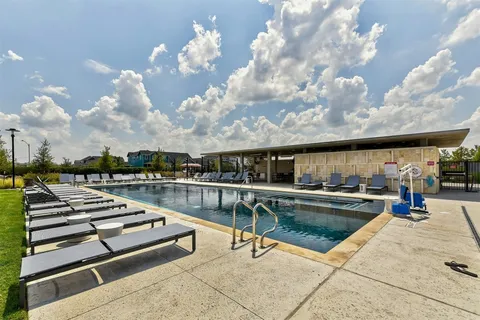 a view of a swimming pool with lounge chair