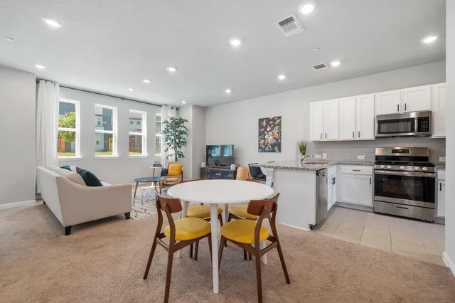 a kitchen with a table and chairs in it