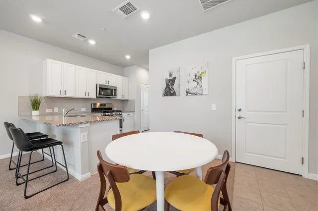a kitchen with a table and chairs in it