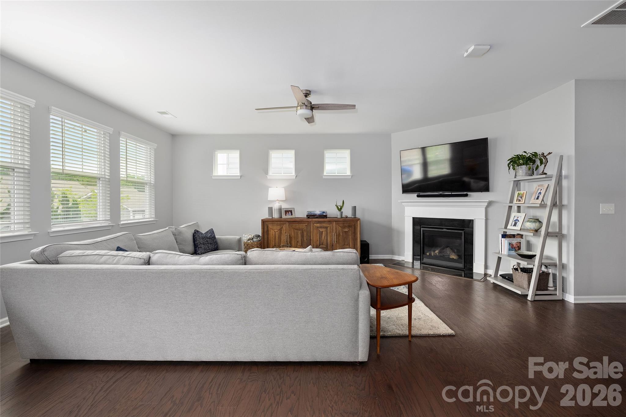 17219 Shearer Road Davidson, NC 28036 - Photo 11 of 34 a living room with furniture a fireplace and a flat screen tv