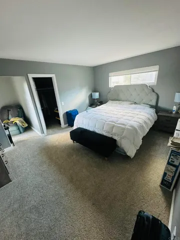 a bedroom with a bed and a chair