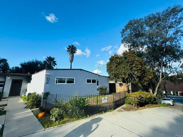 a view of a house with backyard porch and sitting area