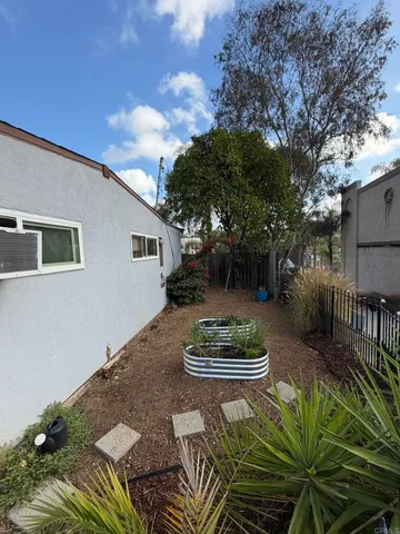 a view of a patio with couches chairs and a small yard