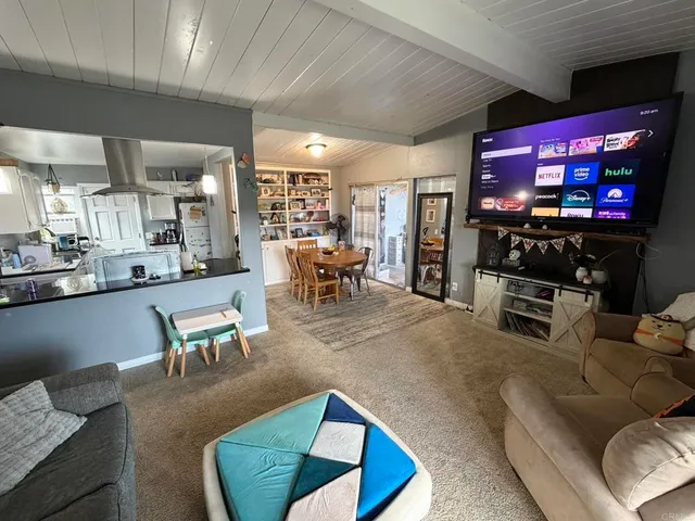 a living room with lots of furniture and a large window