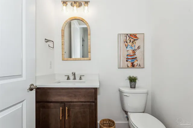 a bedroom with beds a flat tv screen and a ceiling fan