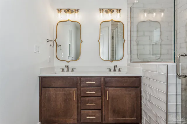 a bathroom with a sink a mirror and a shower