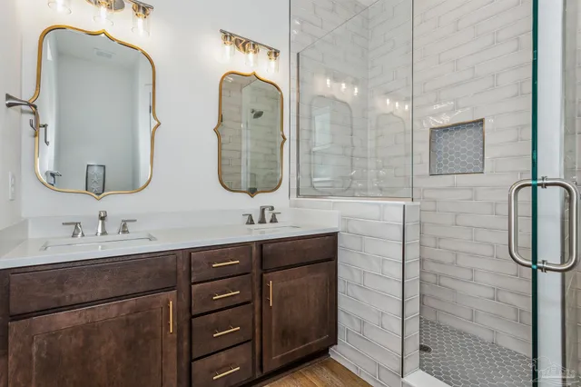 a bedroom with a bed a couch and a flat screen tv