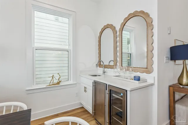 a living room with lots of furniture dining table and a large window
