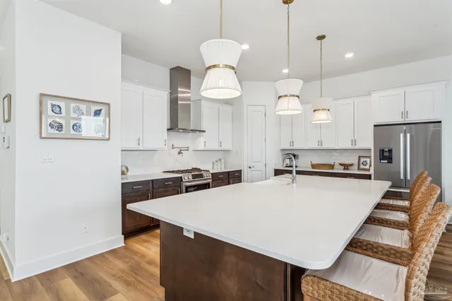 a kitchen with a dining table chairs and view kitchen