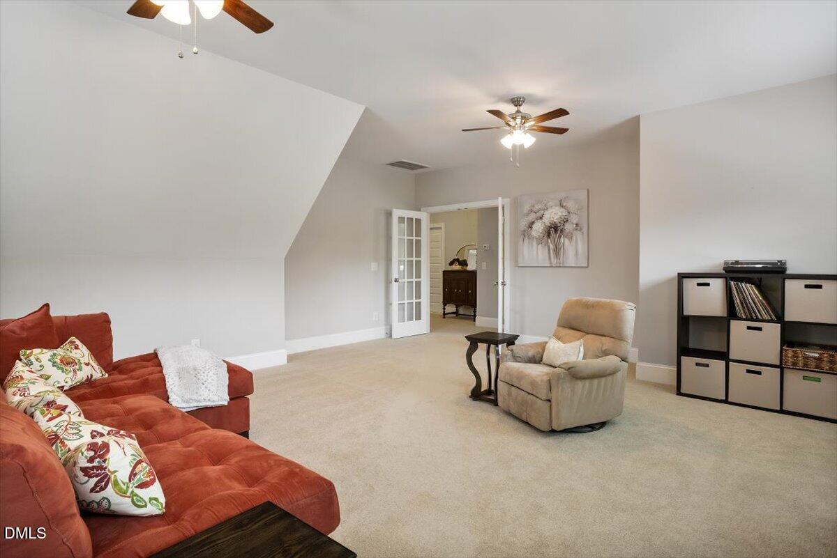 1404 Ivy Lane Raleigh, NC 27609 - Photo 26 of 37 Carpeted flooring, sloped ceiling, double French doors with glass panels, recessed lighting, and a ceiling fan with light fixture