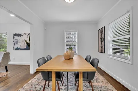 a dining room with furniture and wooden floor