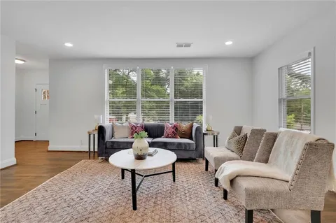 a living room with furniture and wooden floor