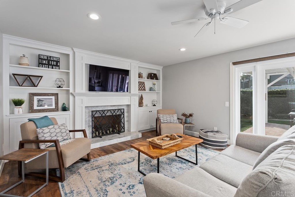 1815 Bailey Drive Oceanside, CA 92054 - Photo 12 of 34 a living room with furniture a flat screen tv and a fireplace