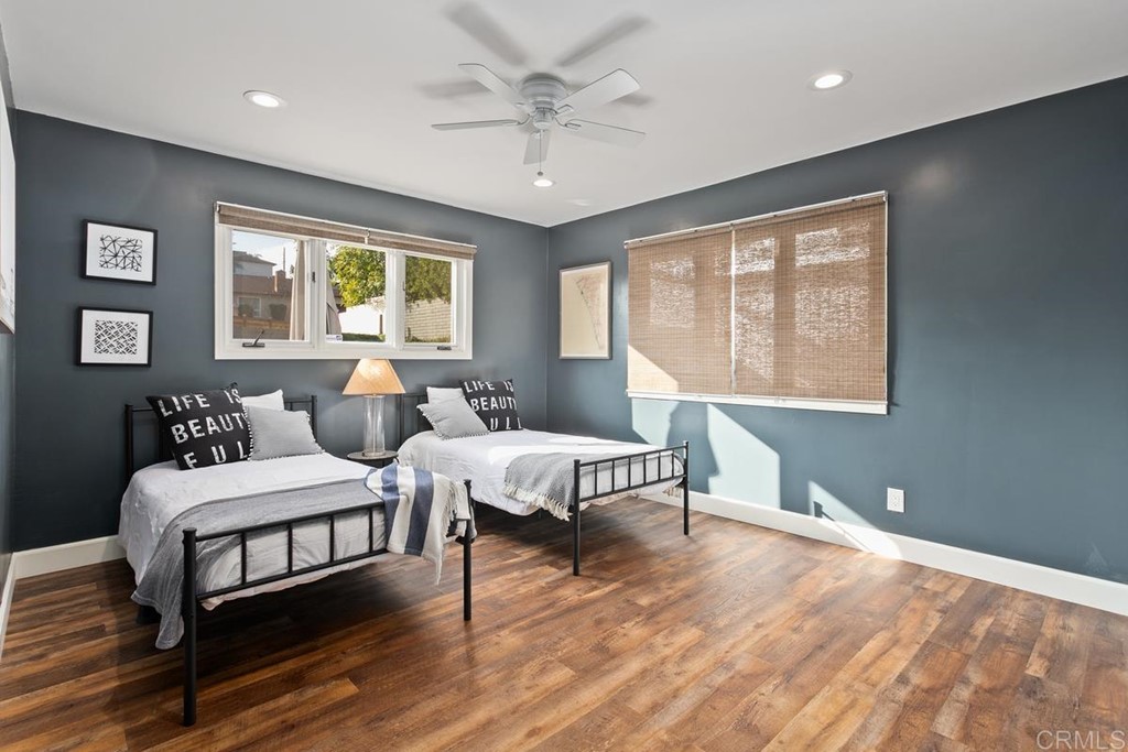 1815 Bailey Drive Oceanside, CA 92054 - Photo 23 of 34 a spacious bedroom with a bed and wooden floor
