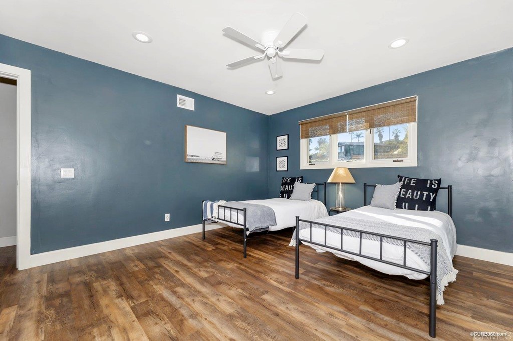 1815 Bailey Drive Oceanside, CA 92054 - Photo 24 of 34 a bedroom with a large bed a chandelier and a window