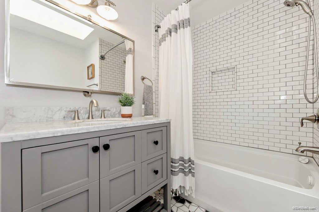 1815 Bailey Drive Oceanside, CA 92054 - Photo 26 of 34 a bathroom with a granite countertop sink a toilet mirror and bathtub
