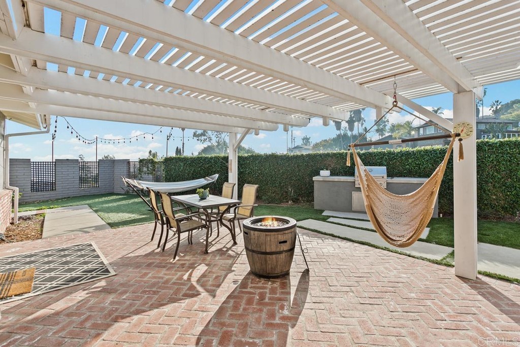 1815 Bailey Drive Oceanside, CA 92054 - Photo 27 of 34 a view of a patio with a table and chairs and potted plants