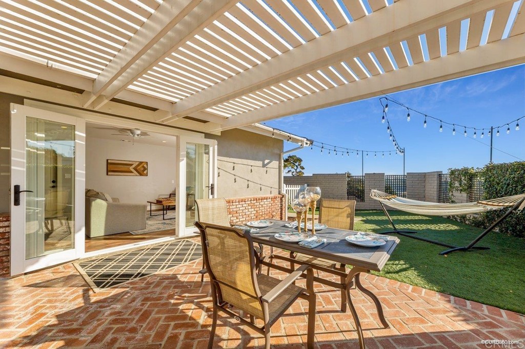 1815 Bailey Drive Oceanside, CA 92054 - Photo 29 of 34 a view of a patio with table and chairs and couches with wooden floor