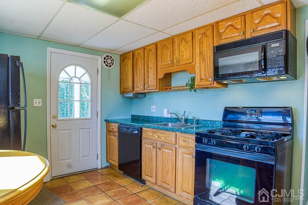 31 Windsor Road Edison, NJ 08817 - Photo 3 of 15 a kitchen with stainless steel appliances granite countertop a stove a sink and a microwave