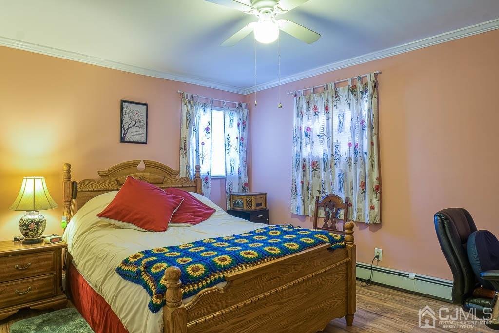 31 Windsor Road Edison, NJ 08817 - Photo 9 of 15 a bedroom with a bed and a chandelier