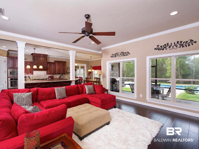 7814 Balin Drive Daphne, AL 36527 - Photo 6 of 26 Spacious Great Room with beautiful floors, a fireplace, built in shelving and a great view of the beautiful pool area connect with the kitchen for an awesome entertaining space!