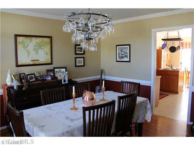 150 Stonburg Road Clemmons, NC 27012 - Photo 4 of 16 Dining Room. Hardwood flooring, Wainscoting and convenient to the kitchen.