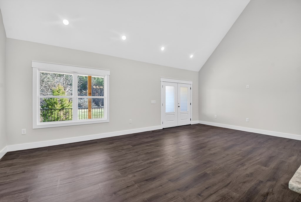 584 Brannon Nix Road Young Harris, GA 30582 - Photo 16 of 36 an empty room with wooden floor and windows