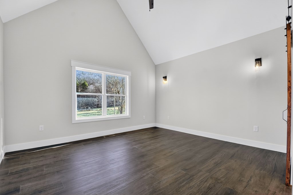 584 Brannon Nix Road Young Harris, GA 30582 - Photo 18 of 36 a view of an empty room with wooden floor and a window